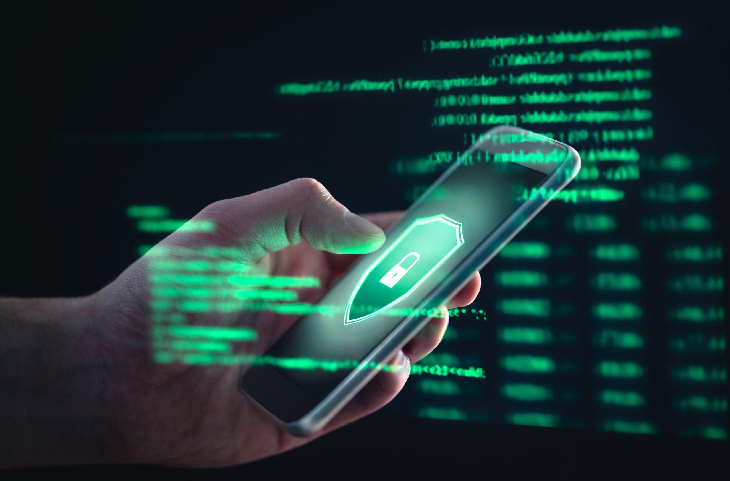 A hand holding a phone with a green padlock warning on the screen, surrounded by abstract green computer text