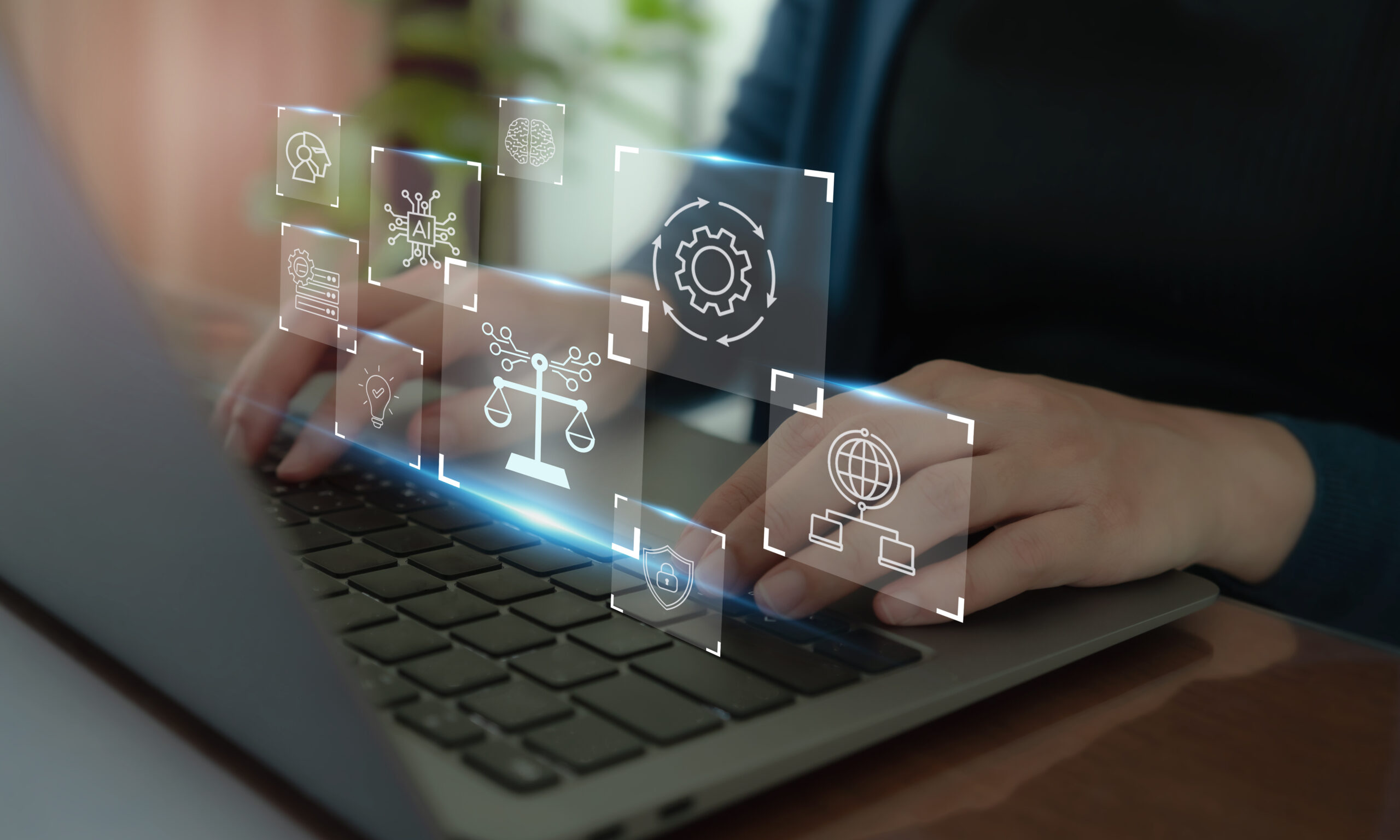 Laptop with 3D figures floating above it, representing security and automation symbols.